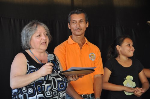 Patricia Rebolledo receives a ceramic plate and a certficate recognizing Horizon's 40th year.